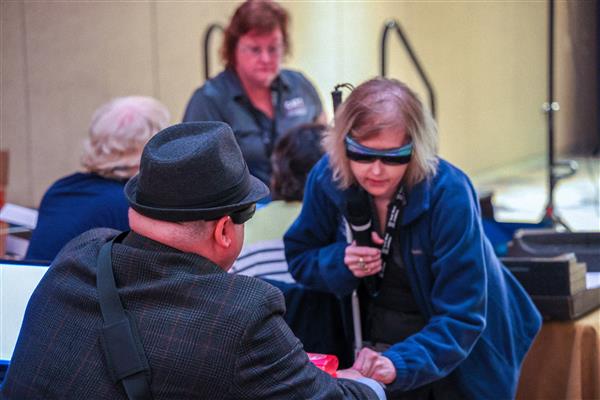 Trainer Jill Dunaway assisting someone with an AT device